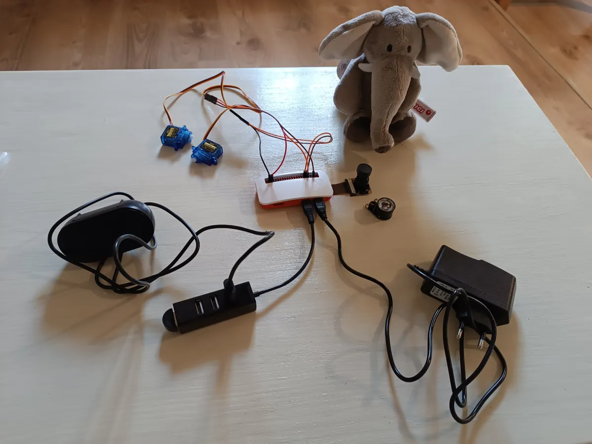 All the ingredients before stuffing them into the toy. You'll spot an extra servo, it was meant to move the arms, but the board couldn't power everything, so only the head servo made the cut.
